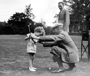 Teaching Prints: Boys Golf Championship John Havers, aged 4, being taught the game by his uncle