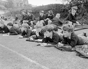 Bored Prints: Boys lying on the grass watching a game of cricket at St Chads Cathedral School