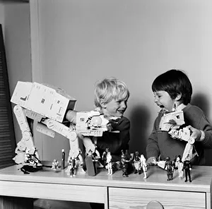 Two boys, Thomas (dark hair) and Robbin playing with their Star Wars toys