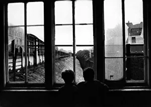 Two boys are watching out for trains at the derelict Heaton Railway Station on 4th