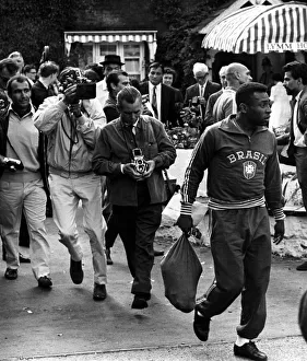 Brazilian football star Pele surrounded by photographers