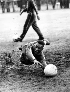 Diving Prints: Brazilian football star Pele takes a turn in goal in a training session at Bolton during