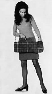 Break into Highland sling: This sausage-shped tartan tote-bag takes all the clutter out