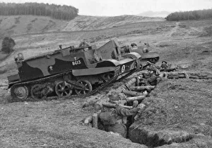 Caerphilly Prints: Bren gun carriers passing over a trench in which troops are taking cover during an army