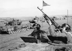 A Bren gunner aims from a Churchill tank turret during a large tank exercise in Yorkshire