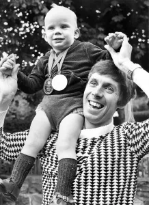 Brendan Foster with his 17 month old son Parul who is wearing his fathers two medals