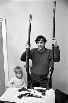 Brian Entwistle with his son, Nigel (5) and his collection of guns - a hand-reproduction