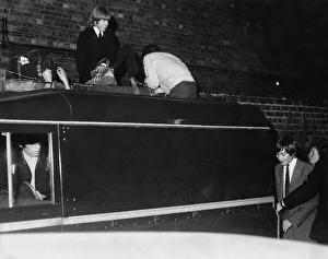 Brian Jones, on the wall Mick Jagger with back to camera Charlie Watts behind Land Rover