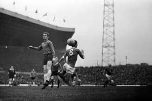 00238 Prints: Brian Kidd of Manchester United in an aerial challenge for the ball with an Ipswich Town