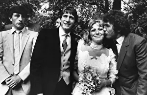 Bride Jackie Manders receiving a kiss from Aston Villa player Peter Withe watched by