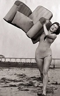 Bridget Burton with a new pneumatic beach armchair which is inflated by a pair of bellows