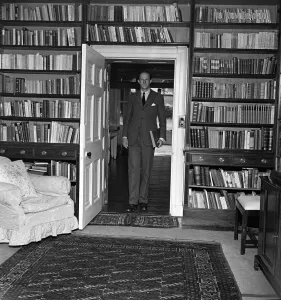 Brigadier Fitzroy Maclean in the book lined study of his home in Yealand Conyers