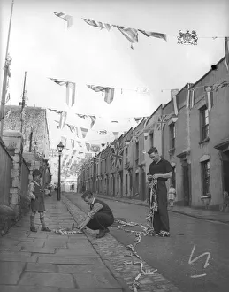 01004 Prints: Bristolians stringing up flags and bunting to celebrate the coronation of Queen Elizabeth
