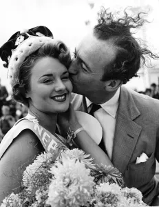 Ties Prints: British Actor David Niven kisses the winner of the Neptunes Daughter