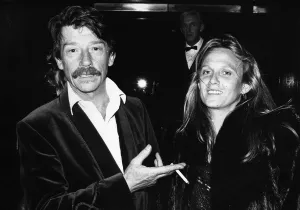 Moustaches Prints: British actor John Hurt arrives at the Royal Albert Hall in London with his wife Donna to