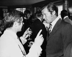 Ties Prints: British actor Roger Moore July 1970 chatting with Bryan Forbes Associated