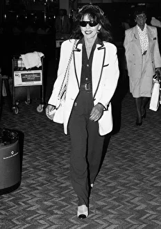 British actress Joan Collins arrives at Heathrow Airport