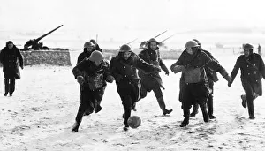 Infantry Prints: British anti aircraft battery playing football in a snow-covered French field. WW2 1940