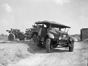 Jeep Prints: British army soldiers inside an all terrain vehicle pulling along a howitzer gun during