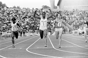 British athlete Sonia Lannaman raises her arms in celebration as she crosses the finish