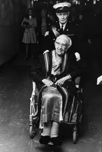 Wheelchair Prints: British author Agatha Christie is wheeled into the Olymiua Theatre as she attends