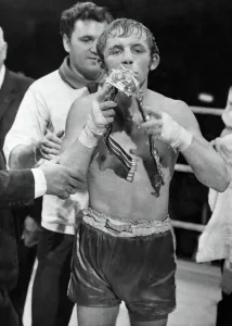 British bantamweight champion boxer Alan Rudkin celebrates by kissing his belt following