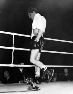 Despair Prints: British boxer Walter Cartier looking dejected as he walks from the ring after creating a