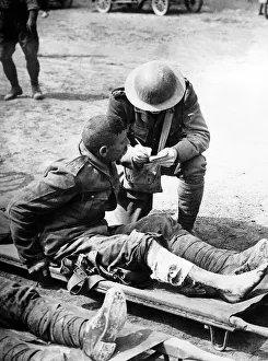 Wounded Prints: British chaplain taking the names of wounded soldiers 1916 after the Battle of the Somme