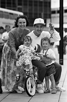 00928 Prints: British cyclist Chris Boardman poses with his family on arrival at Manchester airport as