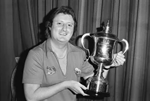 British dart player Eric Bristow poses with the World Championship trophy before his