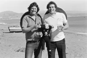 British darts player Eric Bristow poses on the beach with Bobby George at Torremolinos