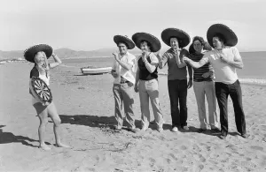 Holidaymakers Prints: British darts player Eric Bristow poses on the beach with Maureen Flowers