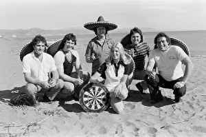 British darts player Eric Bristow poses on the beach with Maureen Flowers