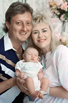 Baby Prints: British darts player Eric Bristow poses at home with his wife Jane
