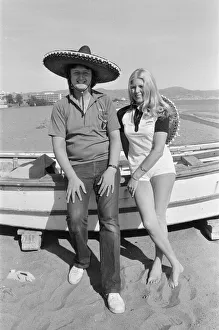 Coast Prints: British darts player Eric Bristow poses with Maureen Flowers on the beach at Torremolinos