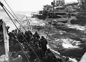 The British destroyer HMS Fury refuels from the cruiser HMS Trinidad despite heavy seas