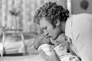 Former British European Heavyweight champion boxer Joe Bugner kisses his new born baby