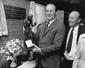 Former British Heavyweight champion boxer Henry Cooper holds a bronze statue of himself