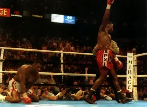 British Heavyweight champion iLennox Lewis raises his arm in celebration after knocking