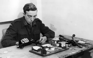 01469 Prints: A British LAC enjoying spare time with a model aircraft kit. 7th December 1944