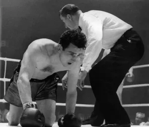 British middleweight boxer John Cowboy'McCormack on the canvas after being