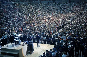 Beatles Colour Prints: British pop group The Beatles playing to a huge crowd out a packed out music venue during