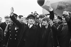 Arrival Prints: British pop group The Beatles wave to fans on their arrival in New York for the band