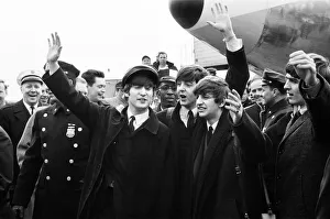 Arrival Prints: British pop group The Beatles wave to fans on their arrival in New York for the band