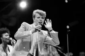 British pop singer David Bowie performing on stage during the Live Aid concert at Wembley