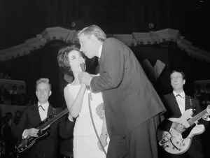 British pop singer Mike Sarne performing on stage at the Pop Prom at the Royal Albert