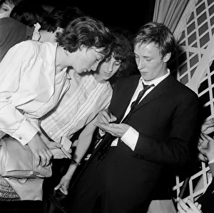 British pop singer Mike Sarne signing autographs for female fans