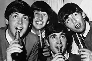 British pop stars The Beatles pose drinking bottles of Coca Cola during a photoshoot