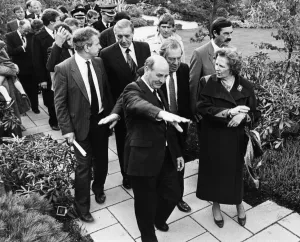 01037 Prints: British Prime Minister Margaret Thatcher is led by Sir Leslie Young through the British