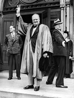 British Prime Minister Winston Churchill gives the famous V Sign in acknowledgement to